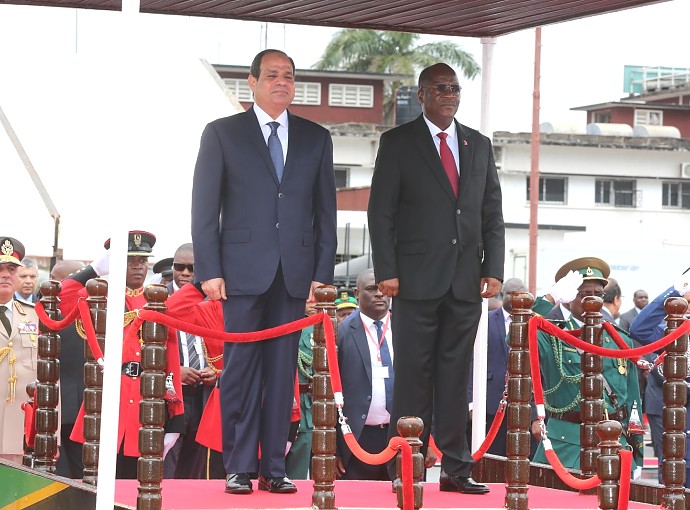 President Dr. John Pombe Magufuli walks with his guest Egyptian President Abdel Fattah El-Sisi   stand for the two countries' National Anthems  and 21-gun salute at the Julius Nyerere International Airport (JNIA) in Dar es Salaam.