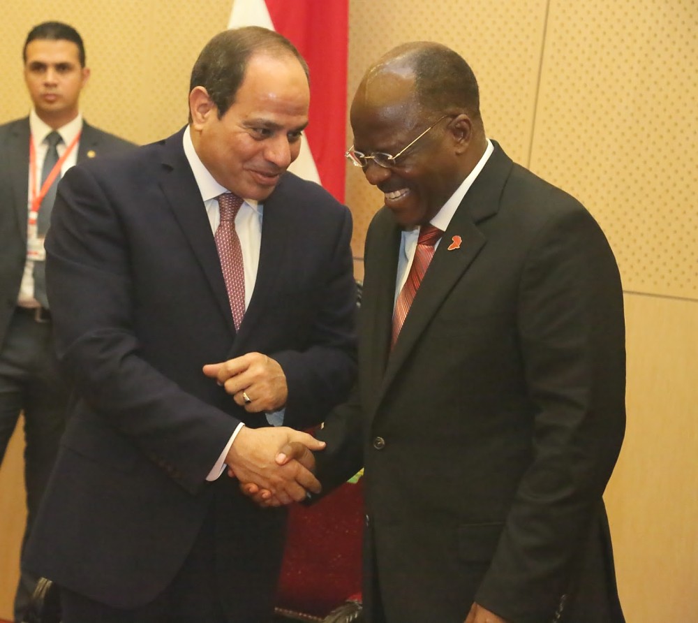 President Dr. John Pombe Magufuli and Egyptian President Abdel Fattah El-Sis share a light moment  after their  addresses